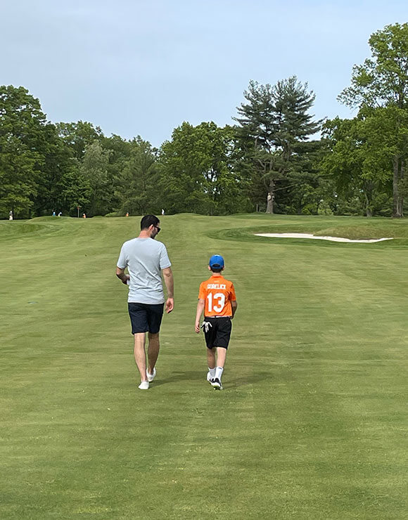 father and son on golf course